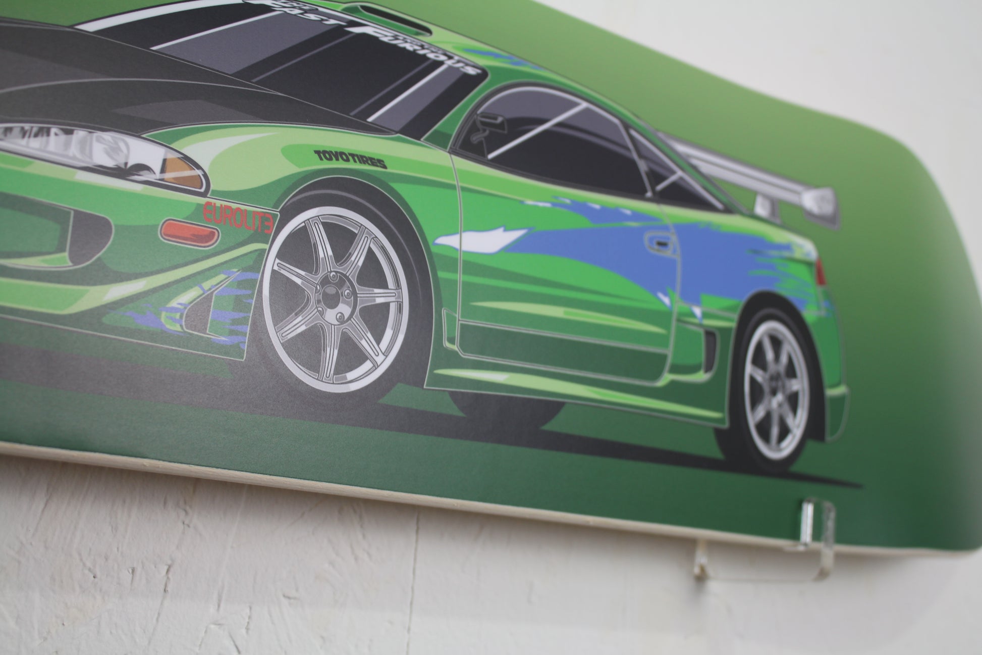 Skateboard deck with a green car design