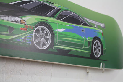Skateboard deck with a green car design