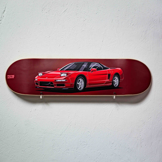 Skateboard deck with a red car design on a white wall
