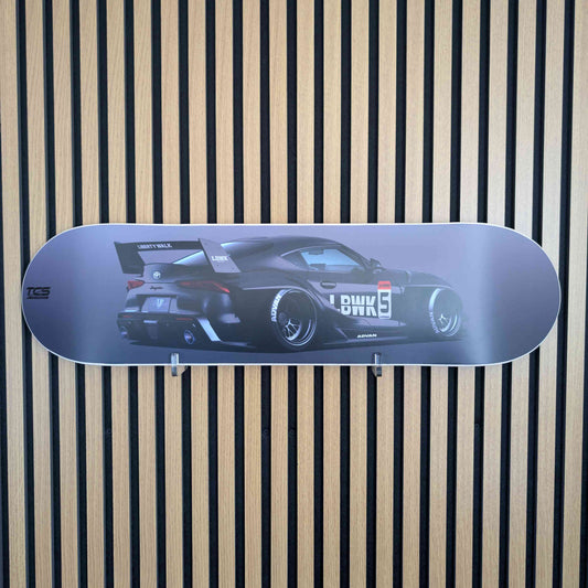 Skateboard deck with car design on a striped background